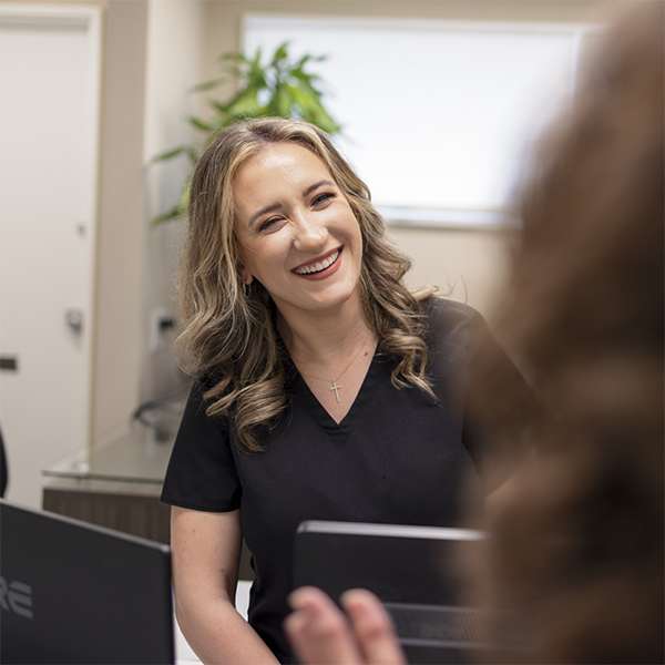 Dental team member greeting a patient