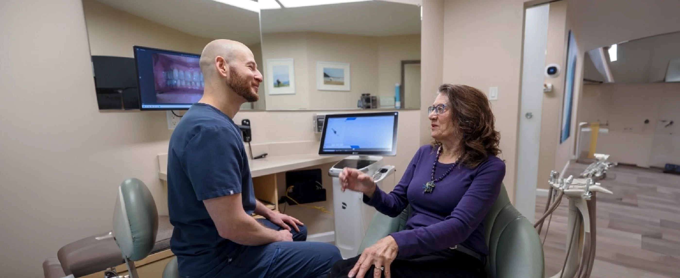 Dentist and patient sitting and talking