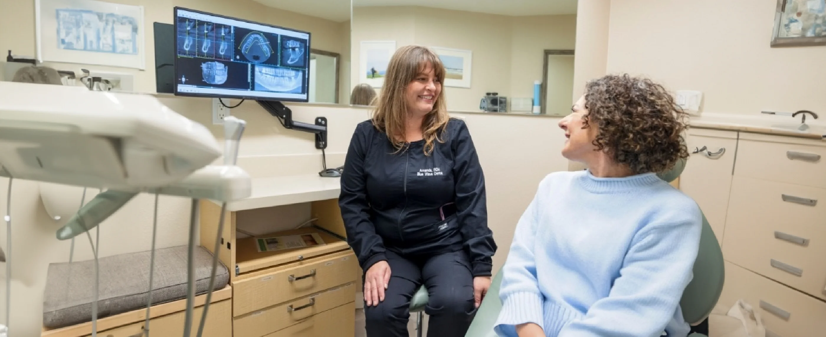 Patient talking to dental team member