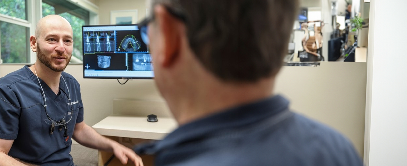 Back view of patient speaking to dentist