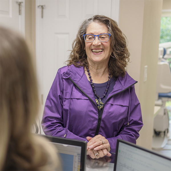 Woman checking in at the front desk of Blue Wave Dental of Walnut Creek