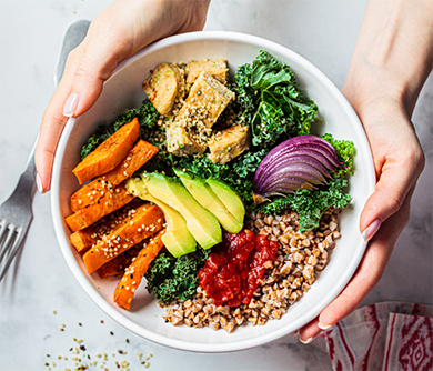 Holding a bowl of vegetables and nuts