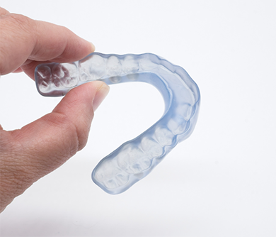 Holding a clear mouthguard