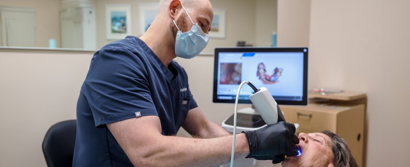 Dentist using intraoral camera on patients mouth