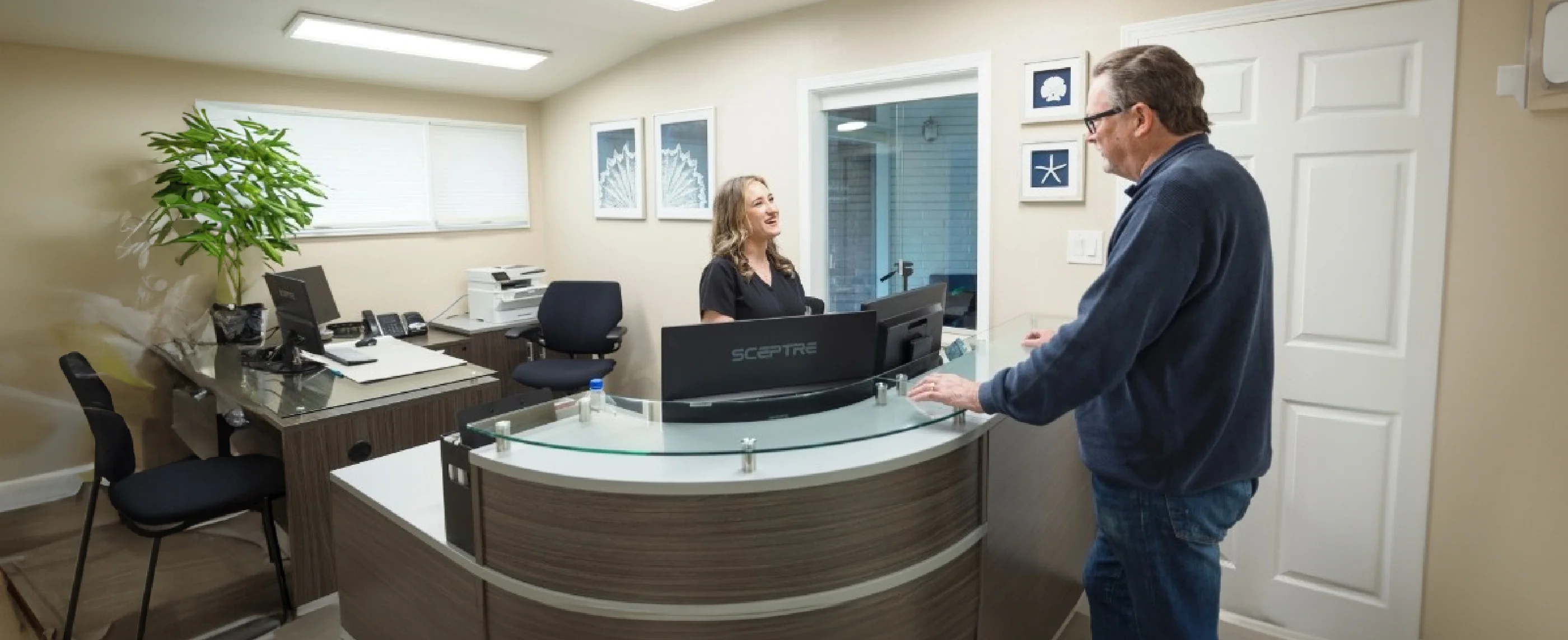 Talking to patient at front desk of dental office