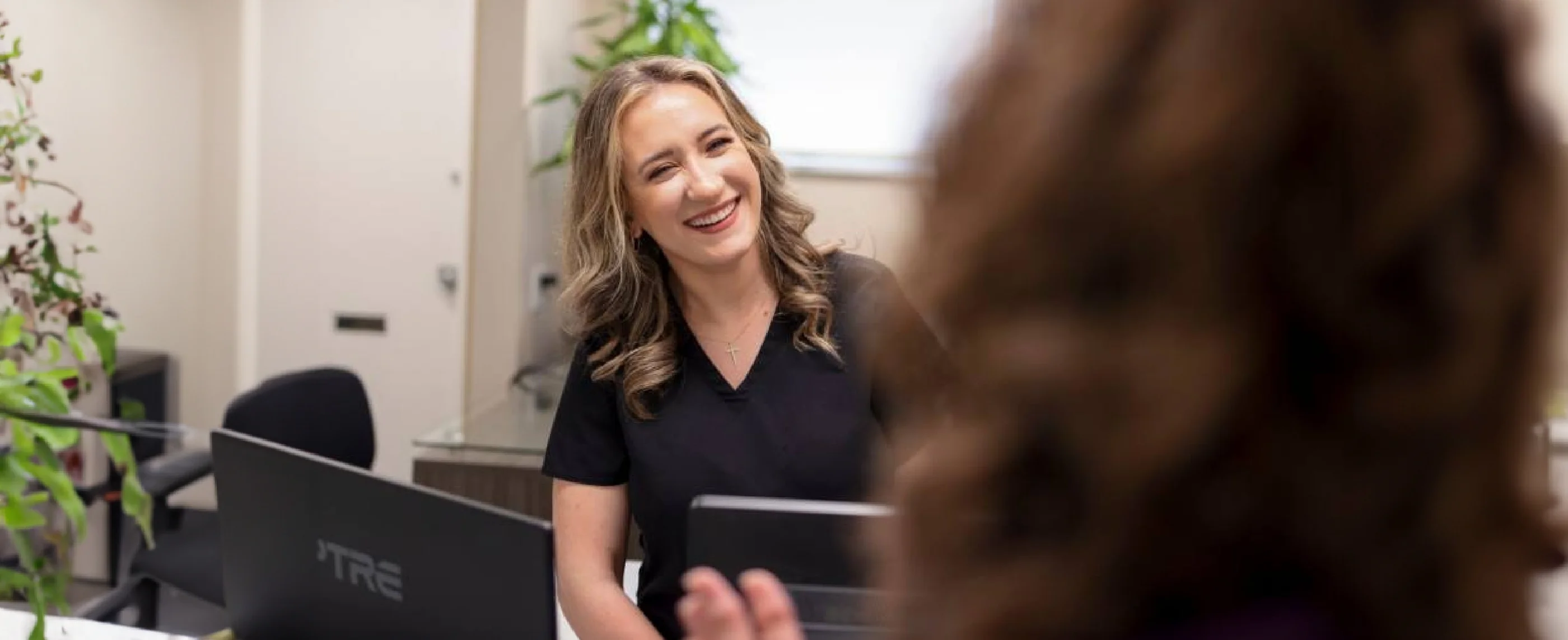 Blonde woman at front desk of dental office