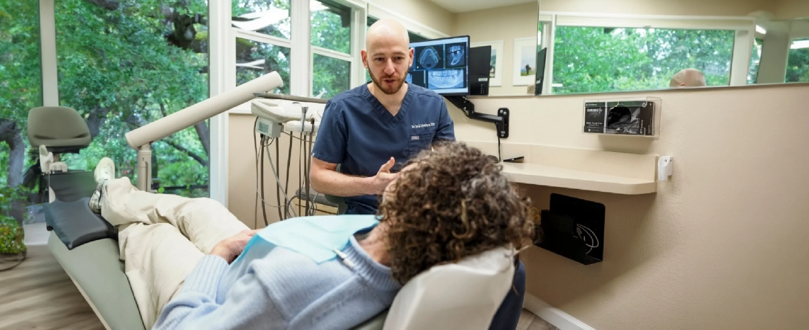 Dentist speaking to a female patient