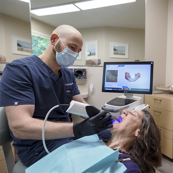 Doctor David taking digital impressions of a patient's teeth