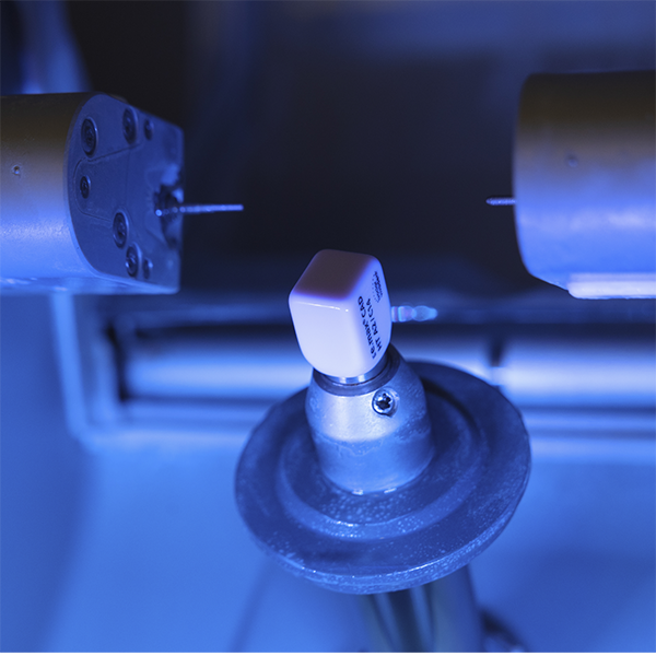 Milling machine creating a dental crown from a ceramic block