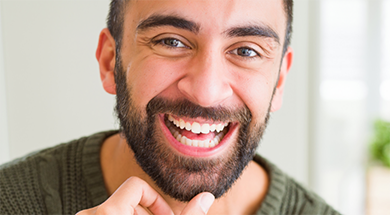 Smiling man with short facial hair